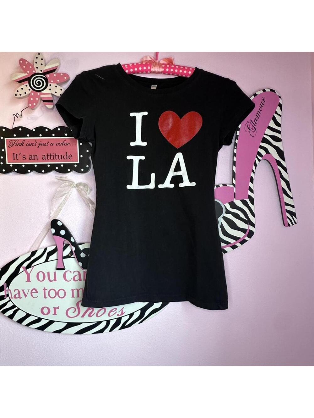 Black fitted graphic tee with bold “I Love LA” print on the front.